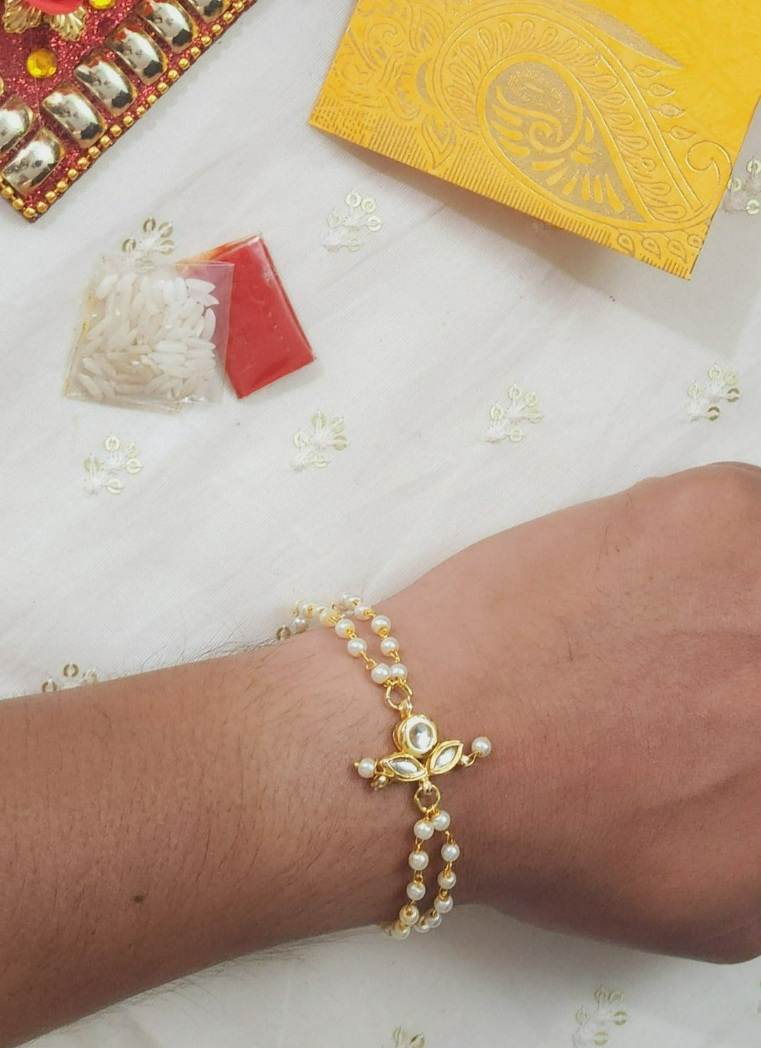Diya Shaped White Kundan Bracelet Rakhi - QUEENS JEWELS