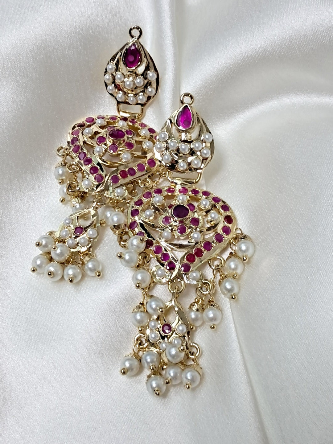 Gold plated ruby red stones & white pearls petal shaped jadau chaandbali earrings.