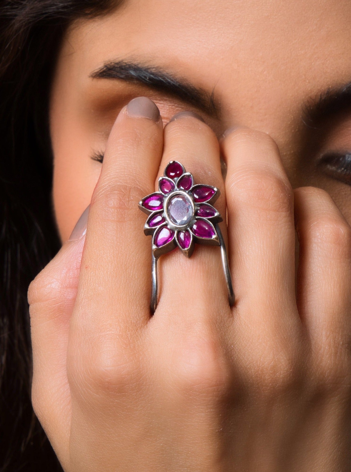 Rose gold flower ring with gemstone center for a feminine touch and unique statement.