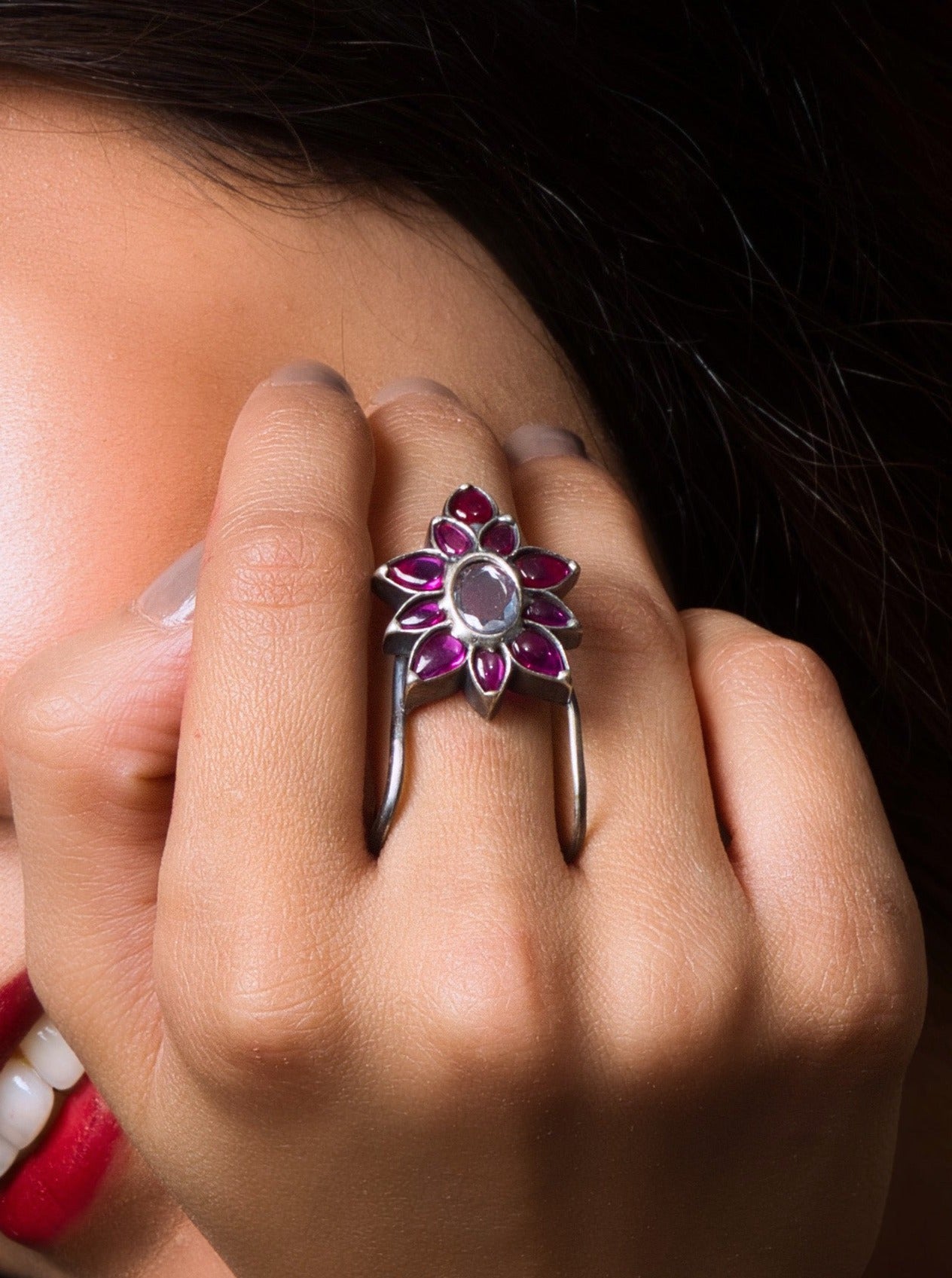 Rose gold flower ring with gemstone center for a feminine touch and unique statement.