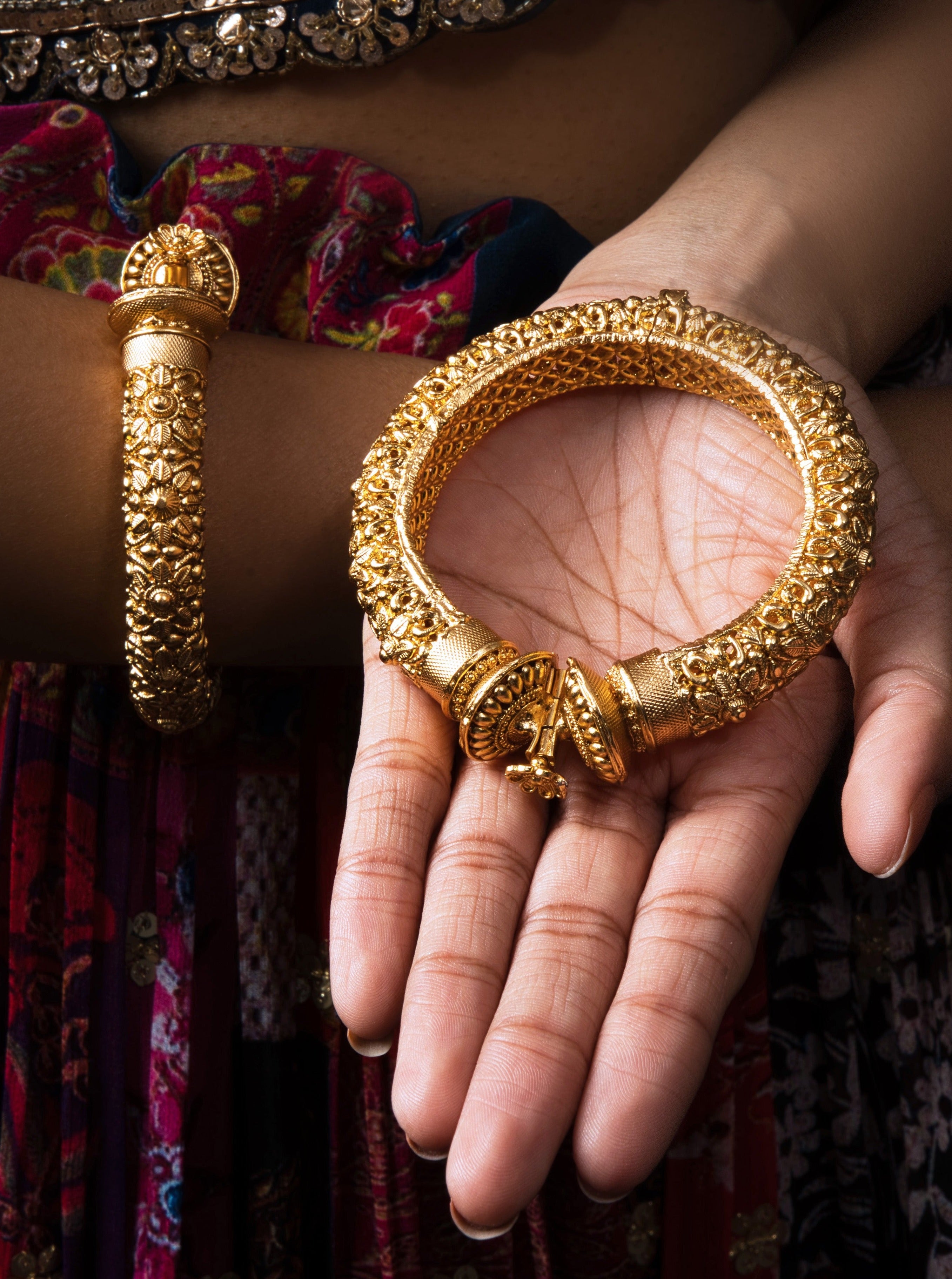 Elevate your style with the Fida Golden Toned Bangle Pair: heritage-inspired, gold-plated, and handcrafted for a meaningful addition to any outfit.