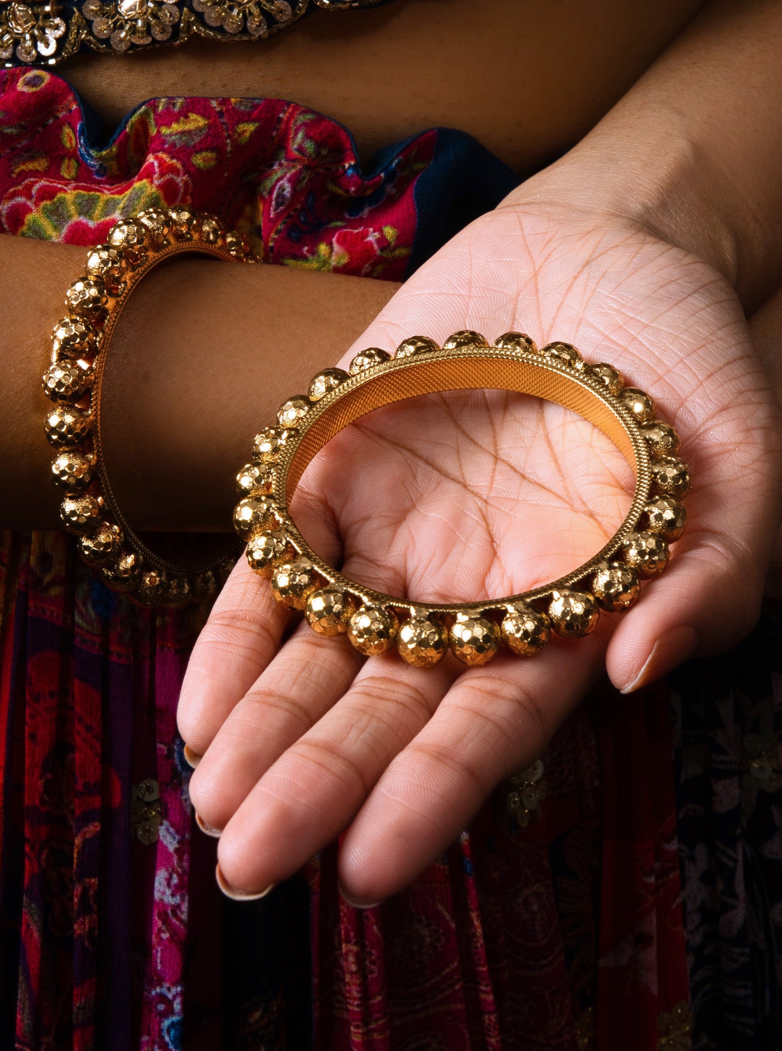 Discover the elegance of our Gold-Plated Polka Dot Bangles, adorned with intricate detailing and cultural significance