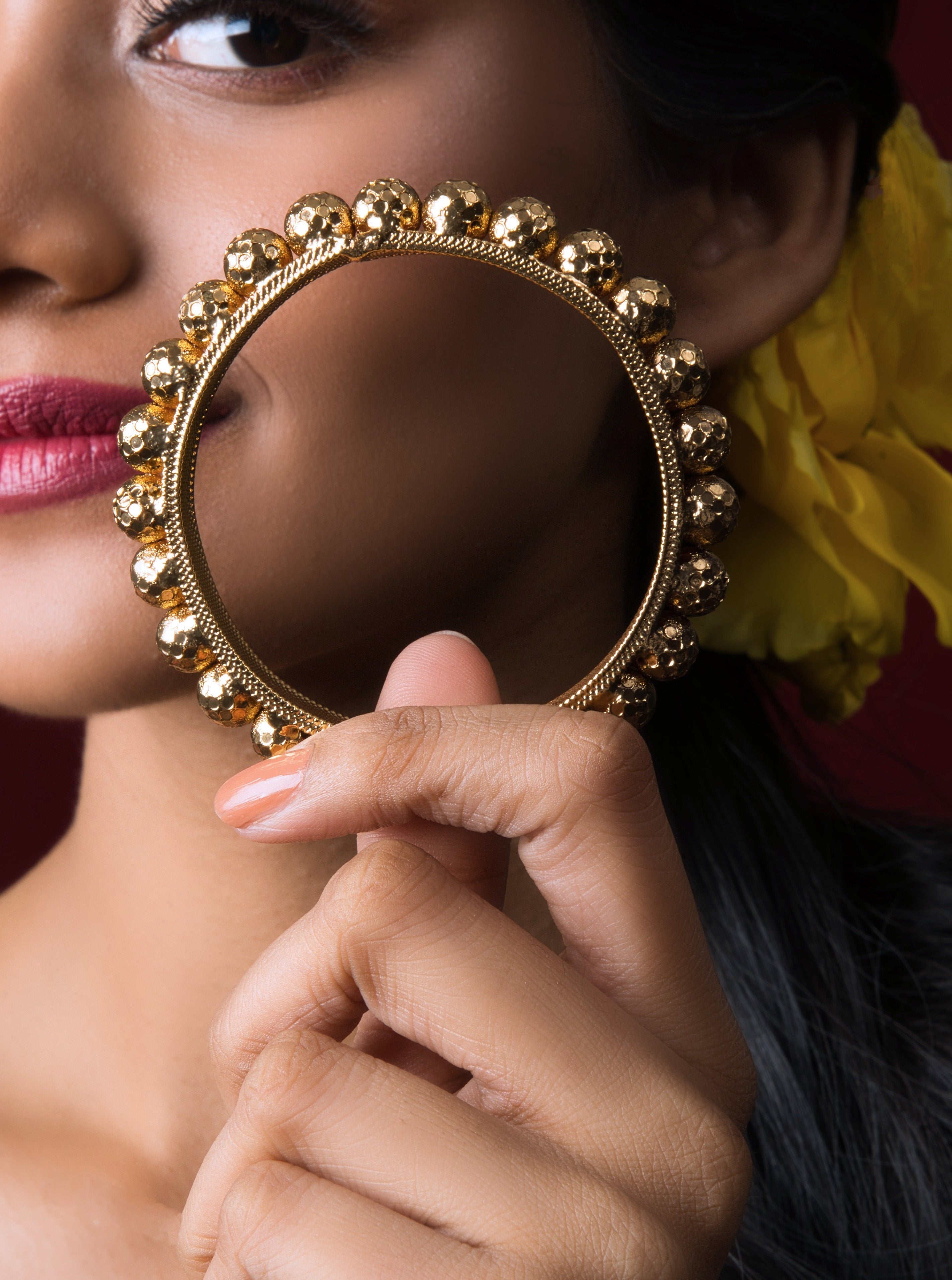 Discover the elegance of our Gold-Plated Polka Dot Bangles, adorned with intricate detailing and cultural significance