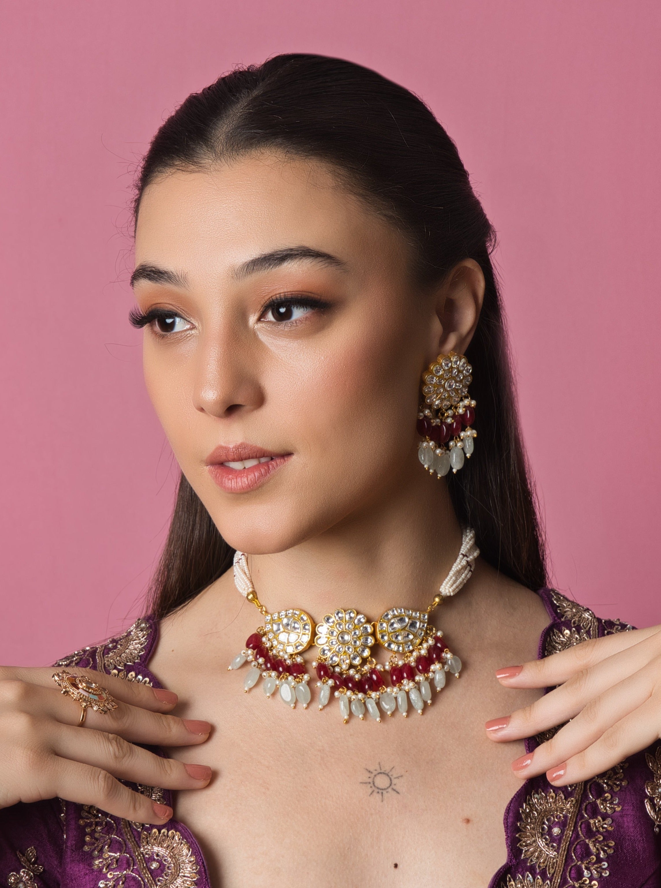 A small Kundan choker with intricate red and white Kundan stones in a droplet design, perfect for festive occasions and bridal wear.