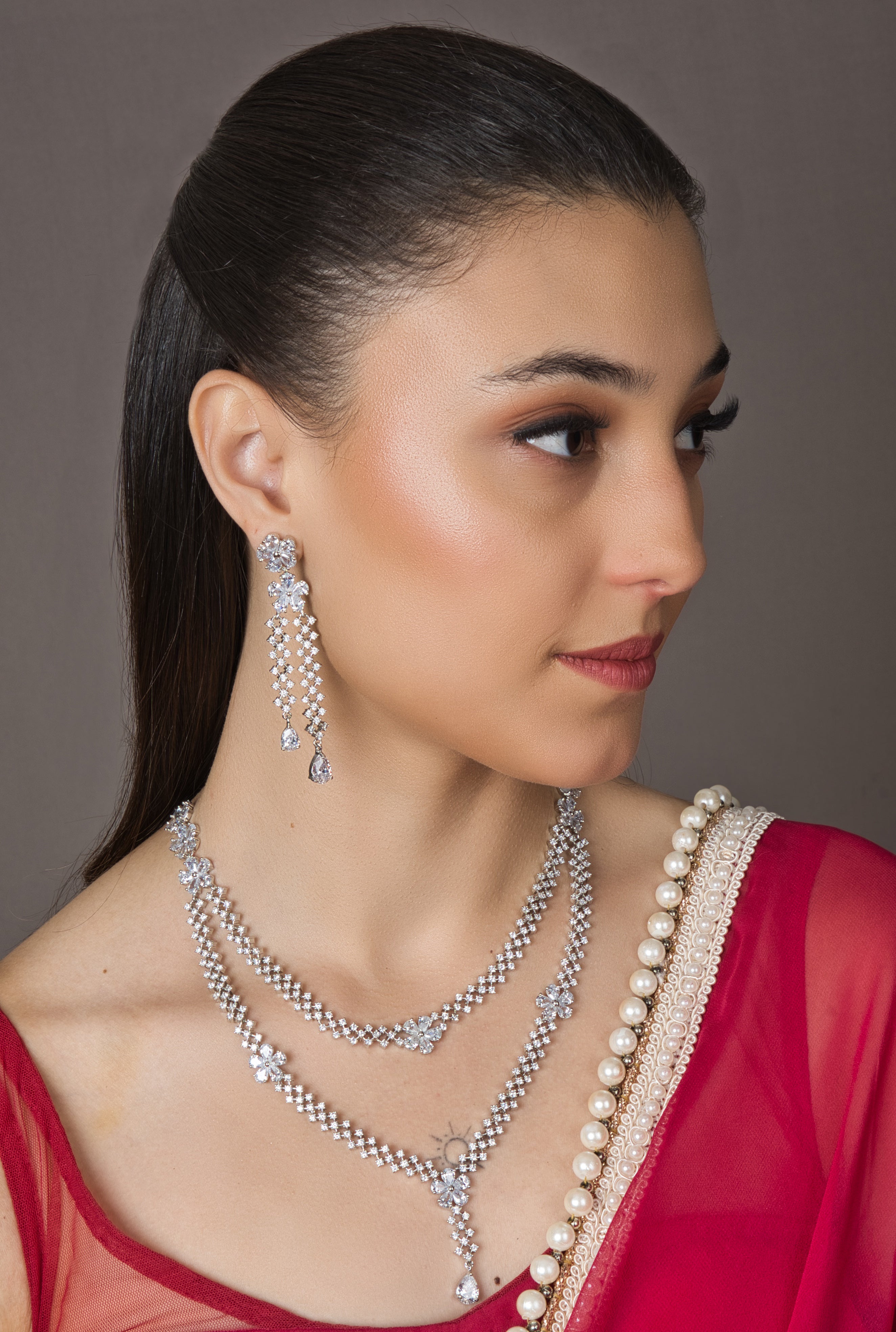 Exquisite American Diamond Set with sparkling diamonds in a necklace and earrings. Adjustable chain on necklace and push-button closures on earrings for easy wear.