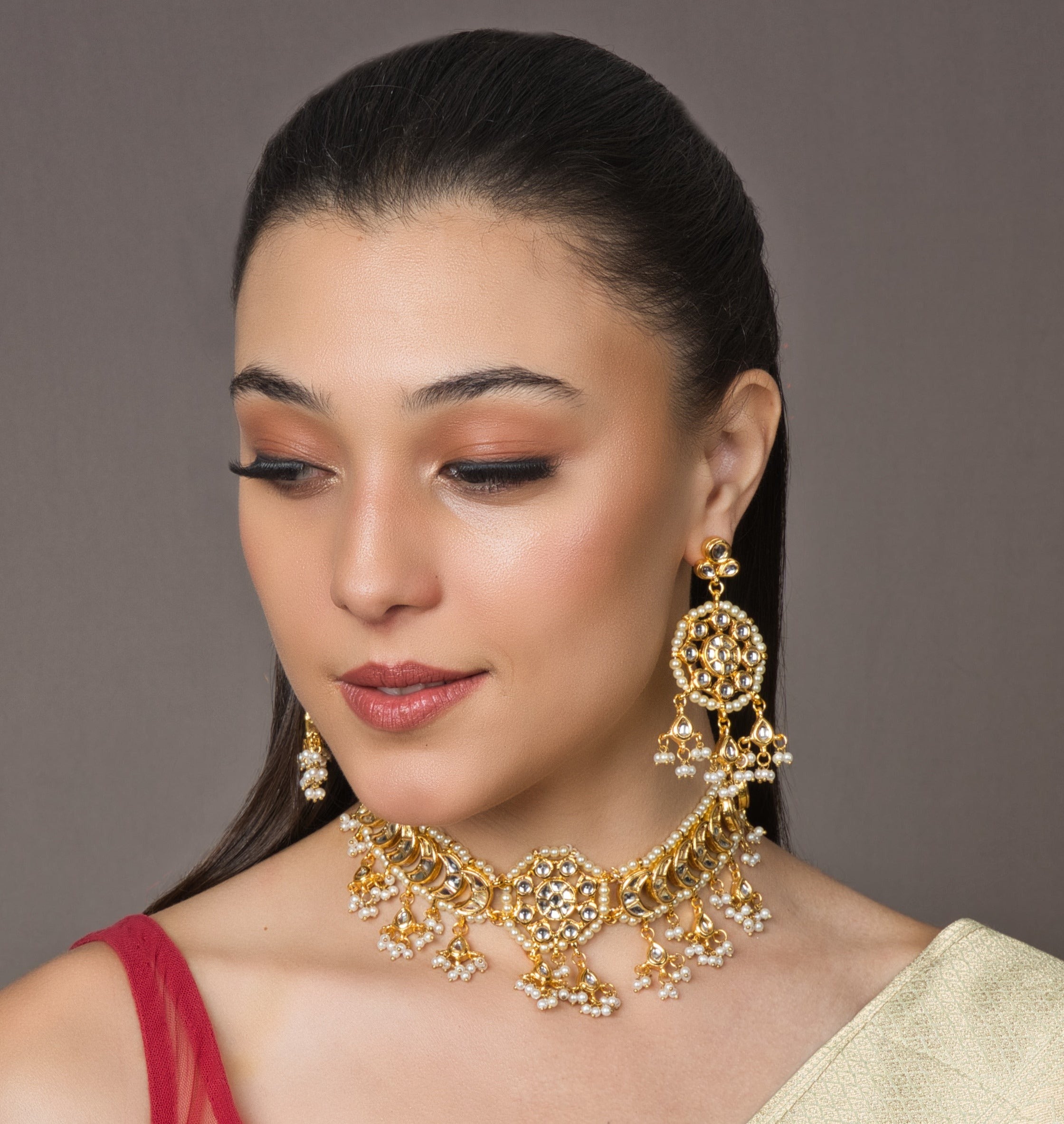 Handcrafted with exquisite golden kundan stones, this set exudes elegance and sophistication