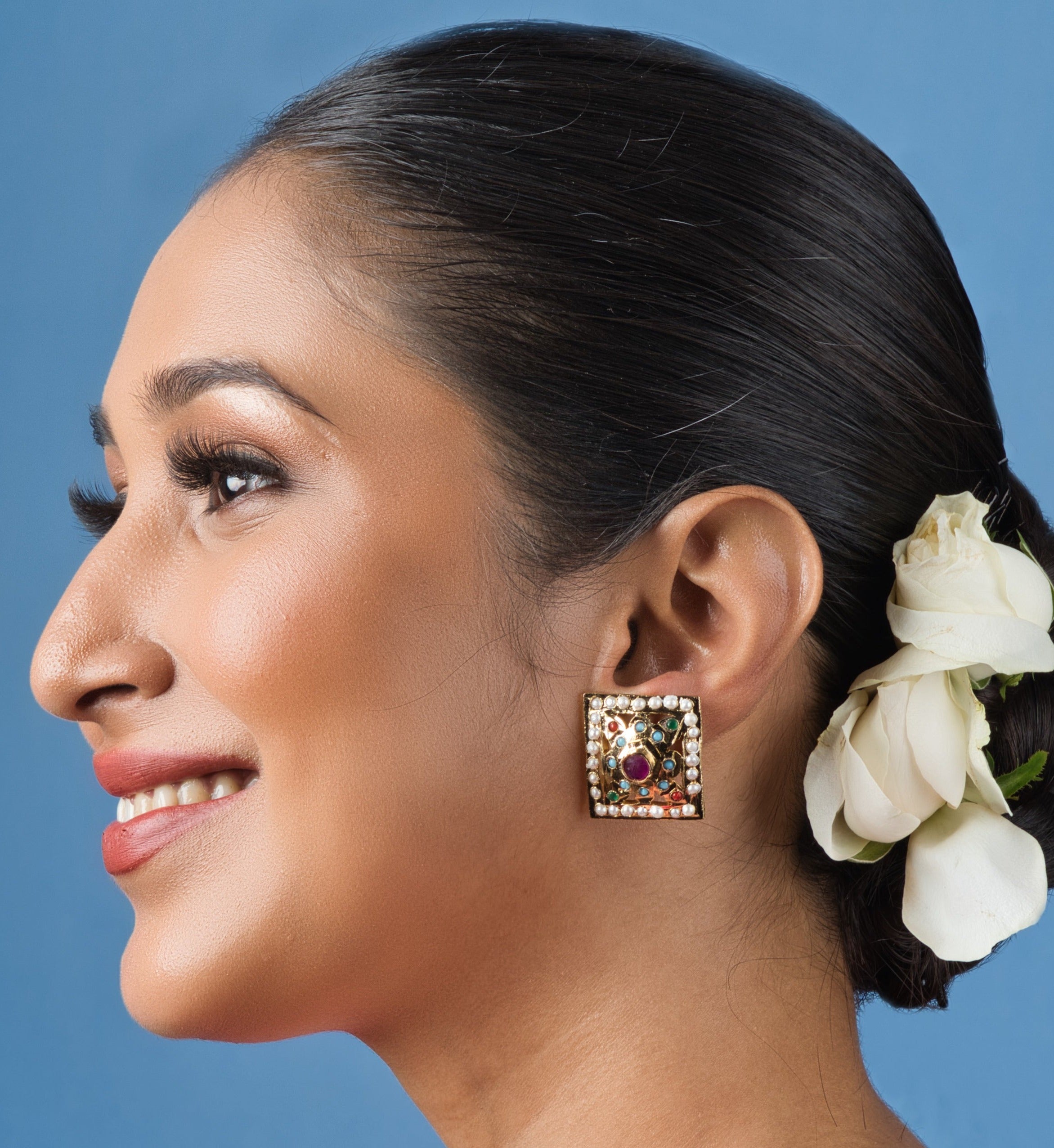 Handcrafted Navratan stud earrings with vibrant stones, adding elegance and sophistication to any ensemble.